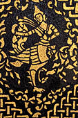 Wat Xieng Thong temple in Luang Prabang, Laos. Detail of the  intricate gold stencilling on black lacquer that decorate the walls of the sim. 